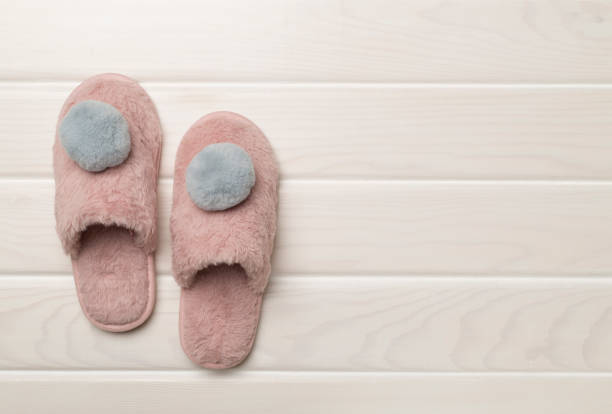 istock Soft pink slippers on wooden background, top view 1810148876