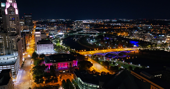 Aerial still image of Downtown Columbus, with the Scioto River and Discovery Bridge, taken by a drone on a clear, Fall night.