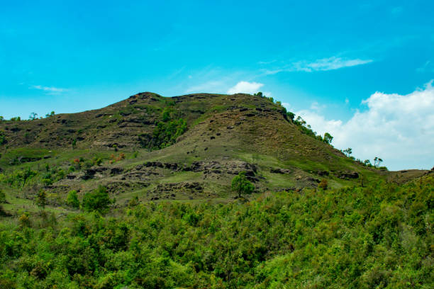 istock Hill is covered in green vegetation and blue sky above 1810161544