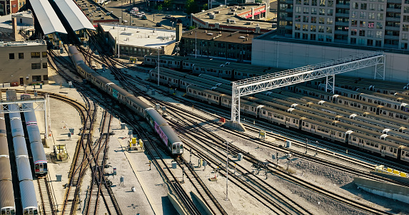 Brisbane, Australia - Nov 20, 2017:  A Queensland Rail peak hour service to Brisbane Airport arrives at Brisbane's Roma Street Station as a service to suburban Cleveland departs. Electric commuter trains passing under maze of electric overhead wires.