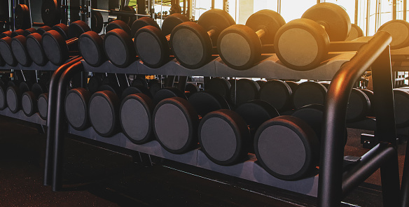 Rows of dumbbells in the gym