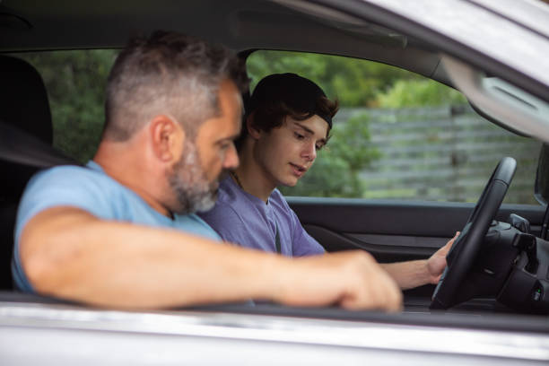 istock Father teaching teenage son to drive 1810192476