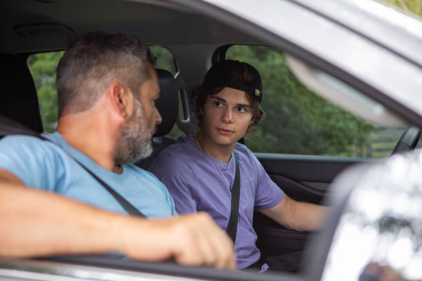 istock Father teaching teenage son to drive 1810192487