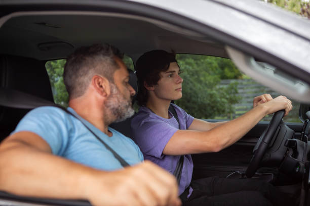 istock Father teaching teenage son to drive 1810192501