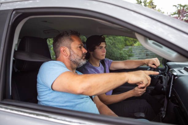 istock Father teaching teenage son to drive 1810192506