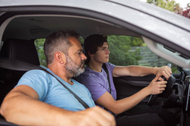 istock Father teaching teenage son to drive 1810192508