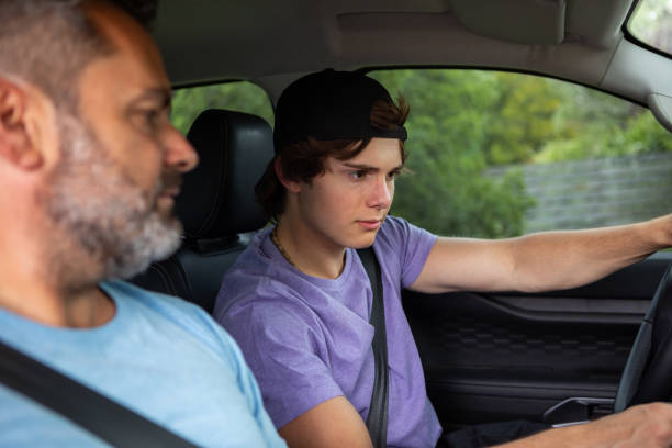 istock Father teaching teenage son to drive 1810192514