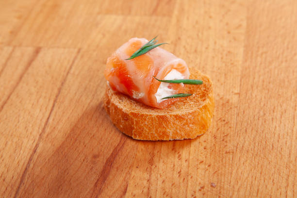 Salmon and cheese on bread, snack, appetizer.