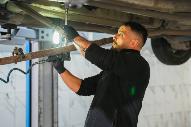 istock man is Working Under the Car in Auto Service. 1810220951