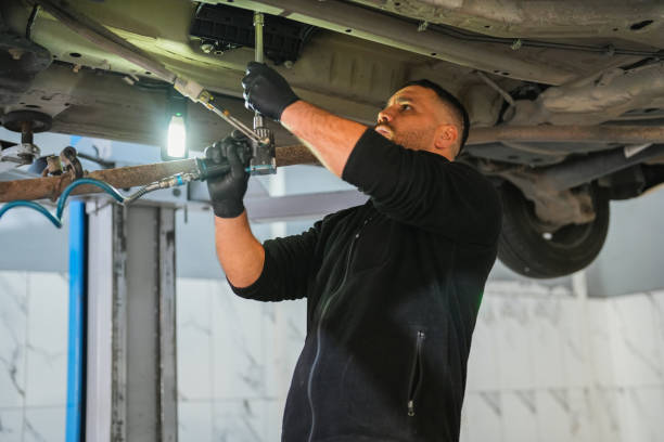 istock man is Working Under the Car in Auto Service. 1810222035