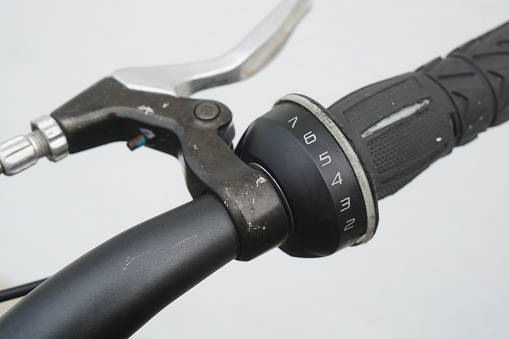 close-up of an old bike with brake handle and a 7-speed gear shifter integrated into the handlebar.