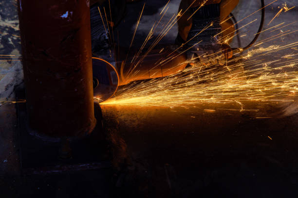istock Worker cuts metal with abrasive disk in industrial factory with a sparks while grinding iron 1810246658