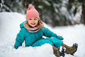 Portrait of Pretty Little Girl Playing With the Snow on a Cold Winter Day