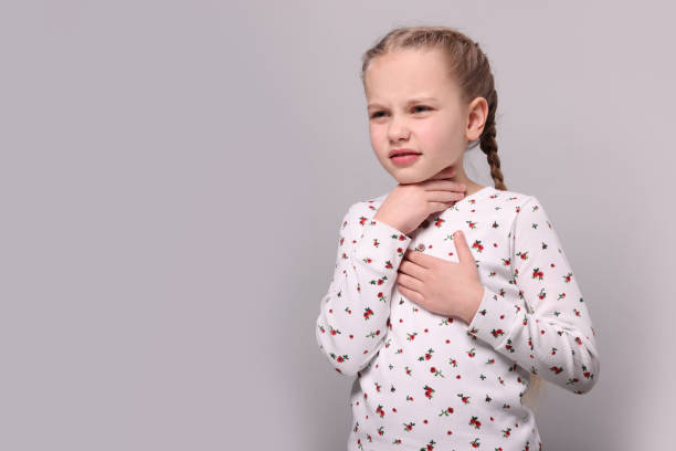 istock Girl suffering from sore throat on light grey background. Space for text 1810256736