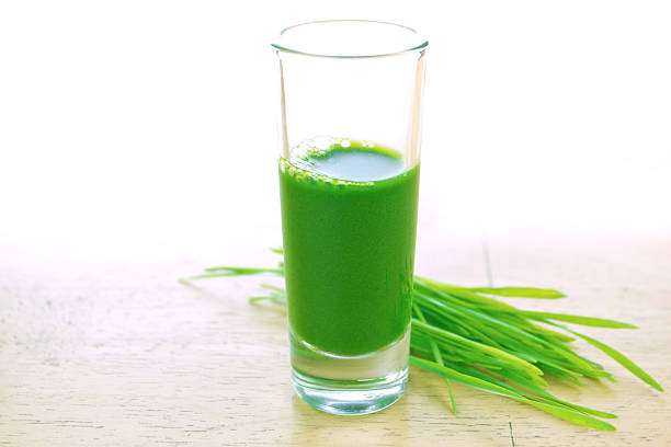 Wheatgrass in glass stock photo