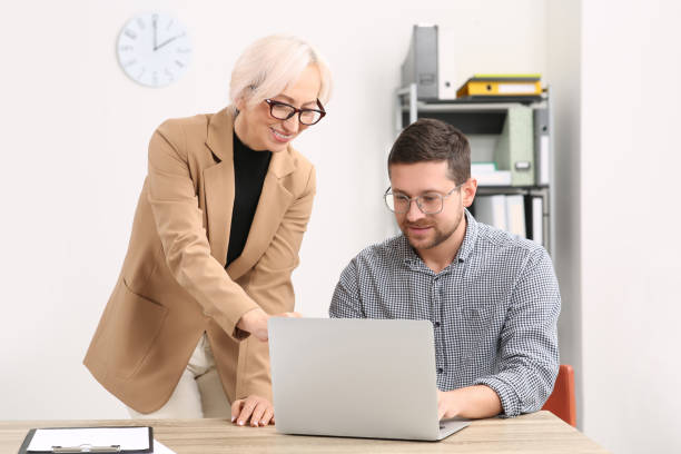 istock Boss and employee with laptop discussing work issues in office 1810324846