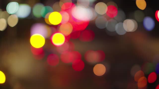 Out of focus background with blurry unfocused city lights and driving cars and car light.