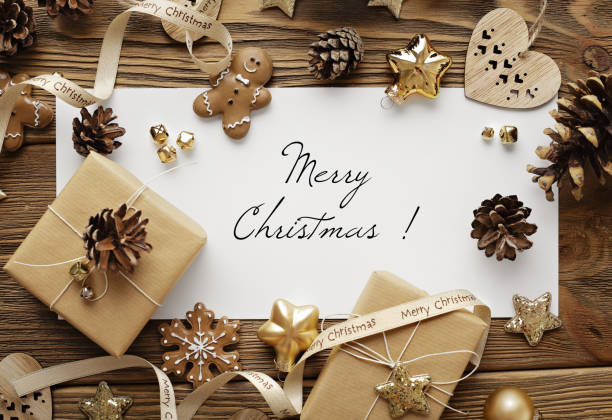 istock greeting card with Christmas tree branches, gingerbread cookies, gift boxes and ornaments on wooden background 1810327448