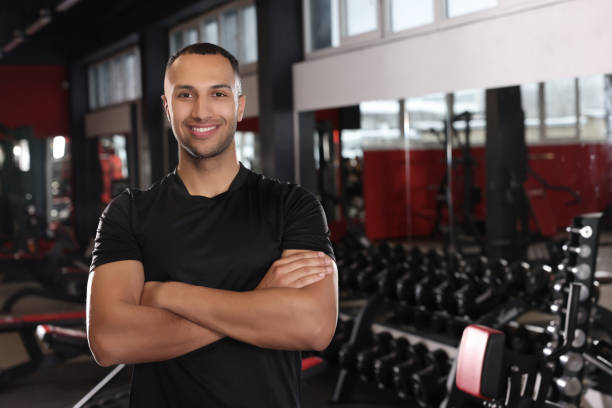 istock Happy trainer in modern gym, space for text 1810374510