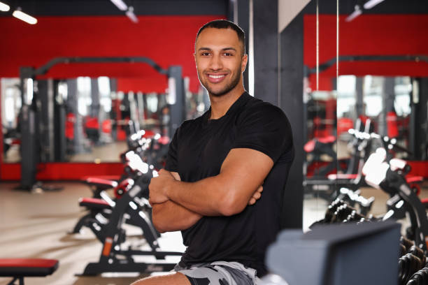 istock Happy trainer in modern gym, space for text 1810374972