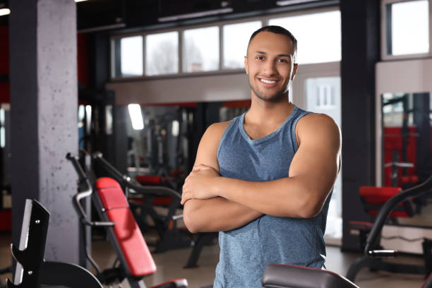 istock Happy trainer in modern gym, space for text 1810396304