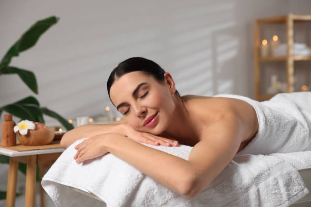 istock Beautiful woman relaxing on massage table in spa salon 1810420280