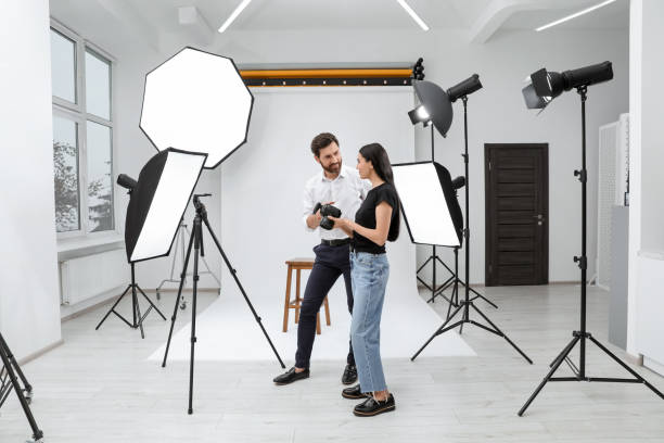 istock Professional photographer and model looking at pictures on camera in modern studio 1810421359