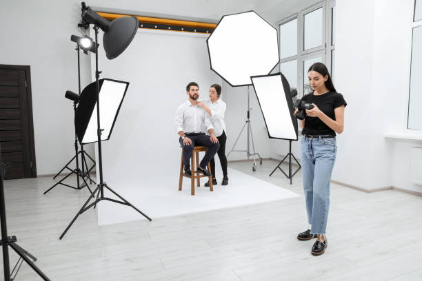istock Professional photographer and stylist working with model in modern photo studio 1810421361