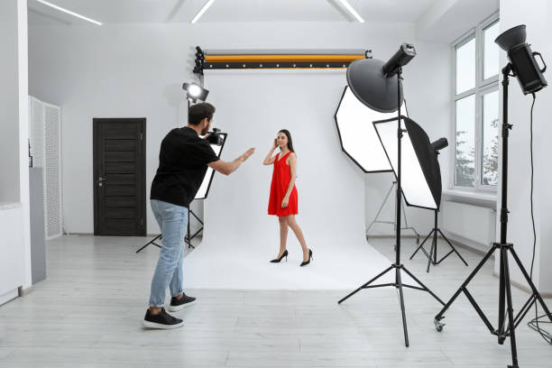 istock Professional photographer working with beautiful model in modern photo studio 1810421884