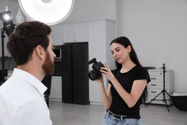 istock Professional photographer working with handsome model in modern photo studio 1810421886