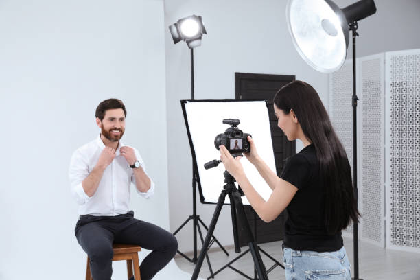 istock Professional photographer working with handsome model in modern photo studio 1810422423