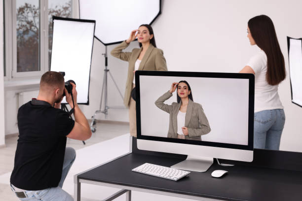istock Professional photographer and assistant working with beautiful model in modern photo studio, selective focus 1810423459