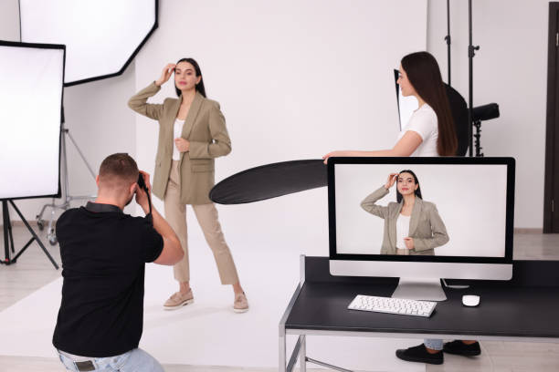 istock Professional photographer and assistant working with beautiful model in modern photo studio 1810423461