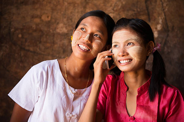 istock Two Myanmar girls using smart phone. 181042625