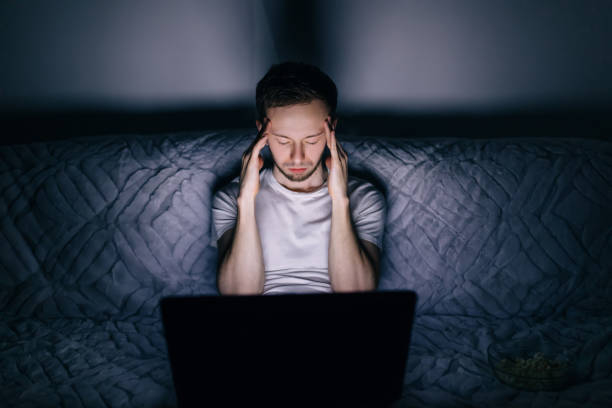 istock Sleepy young caucasian man rubbing head, feels tired after worki 1810437033