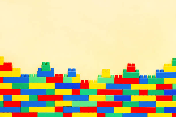 istock Building Brilliance: Educational Toys for kids. Wall from Colorful plastic brick blocks. Copy space. Education, children's creativity 1810437640