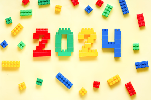 Imaginative Holidays: Constructing 2024 in Colorful Bricks for Kids. Educational toys for kids. Education. Happy New Year and Merry Christmas.