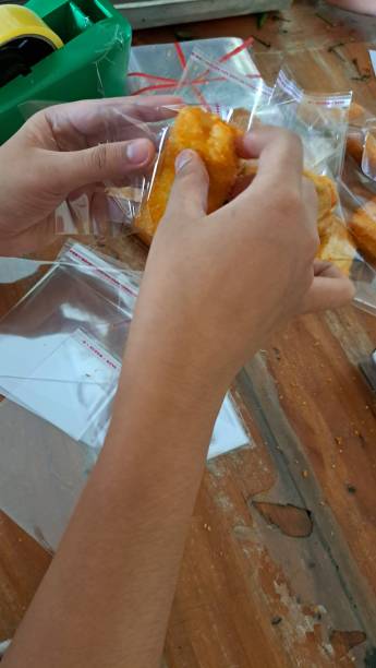 istock A photo of spring rolls being put in plastic, on a table, is very suitable for restaurant promotional media 1810446156