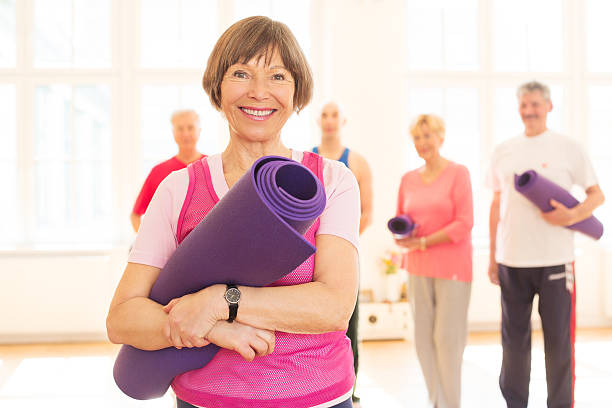 istock Happy senior woman in a yoga studio 181045942