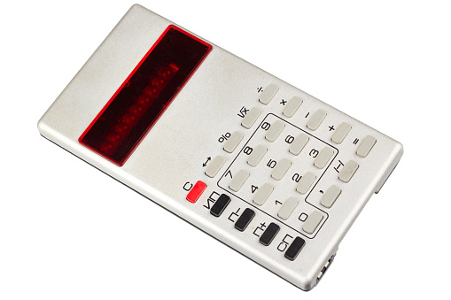 Old vintage pocket electronic calculator isolated on white background