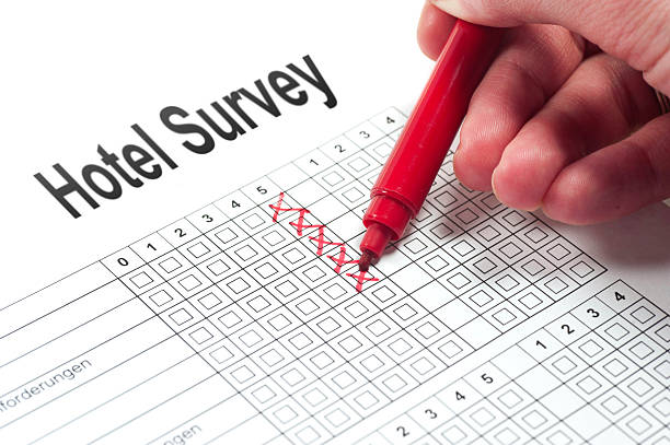 Hotel Survey customer satisfaction paper with human hand and red pen umfrage stock pictures, royalty-free photos & images