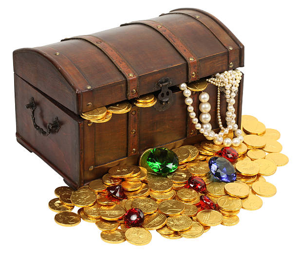 Treasure chest with old coins on the pirate table concept background.