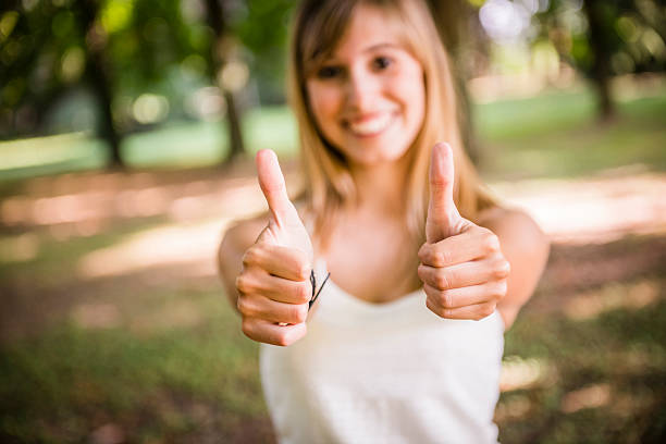 istock Young woman with thumbs up 181046889