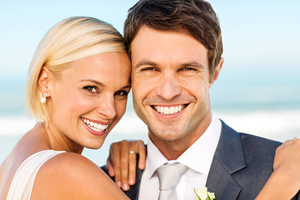 istock Happy Bride And Groom On Beach 181046999