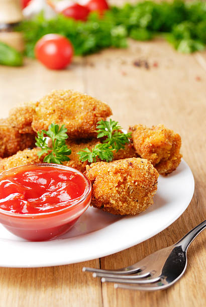 istock Fried chicken nuggets on the plate onto wooden table 181047175