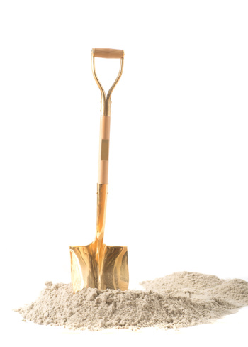 first shovel on heap of sand