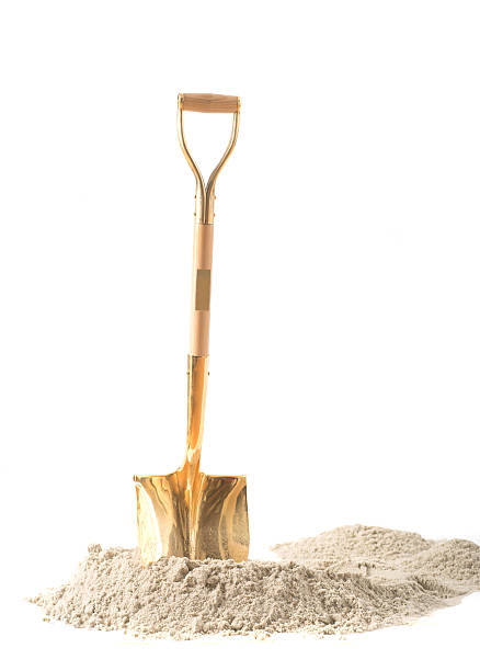 first shovel on heap of sand with white background first shovel on heap of sand shovel in sand stock pictures, royalty-free photos & images