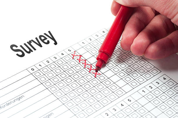 survey with red pen and hand customer satisfaction paper with human hand and red pen umfrage stock pictures, royalty-free photos & images