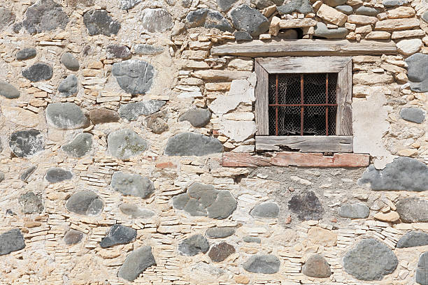 istock grey black  stone wall background with prison window bars Cyprus 181047599