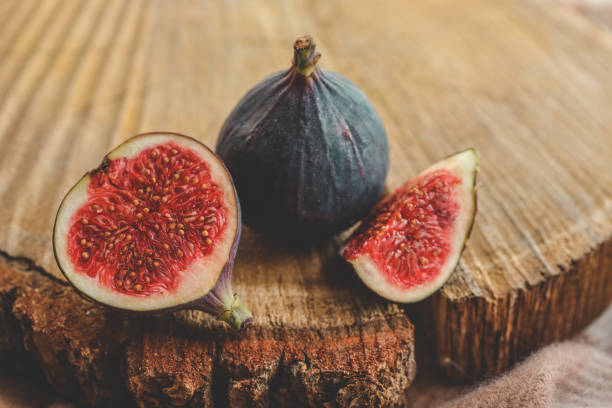 istock A few figs in a bowl on an old wooden background. 1810483656